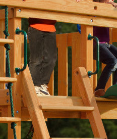 Green metal safety handles mounted on wooden swing set beam with children climbing and sitting nearby