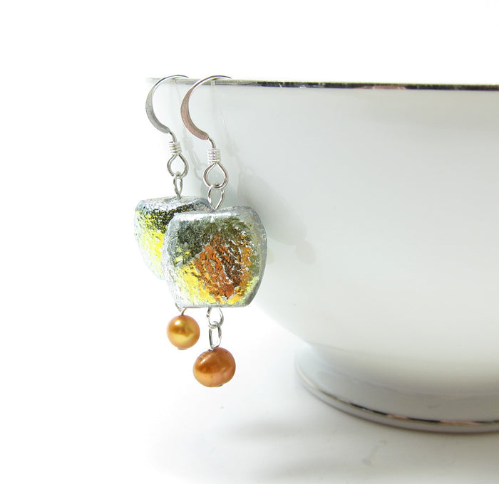 An iridescent and metallic finish gives these glass bead earrings lots of depth and dimension.