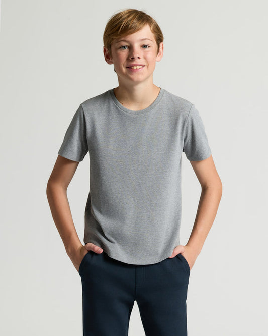 Boy wearing Boys' Heather Gray Classic Curved Hem Crew Neck, hands in pockets.