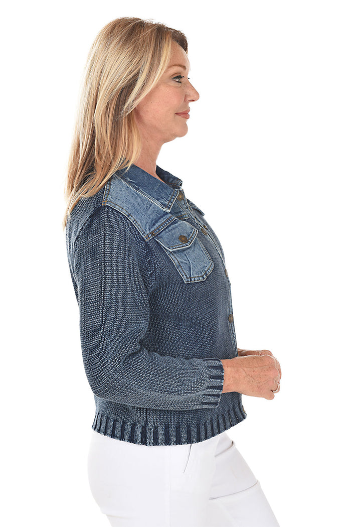 Woman wearing a blue denim sweater jacket on a white background. Side shot.