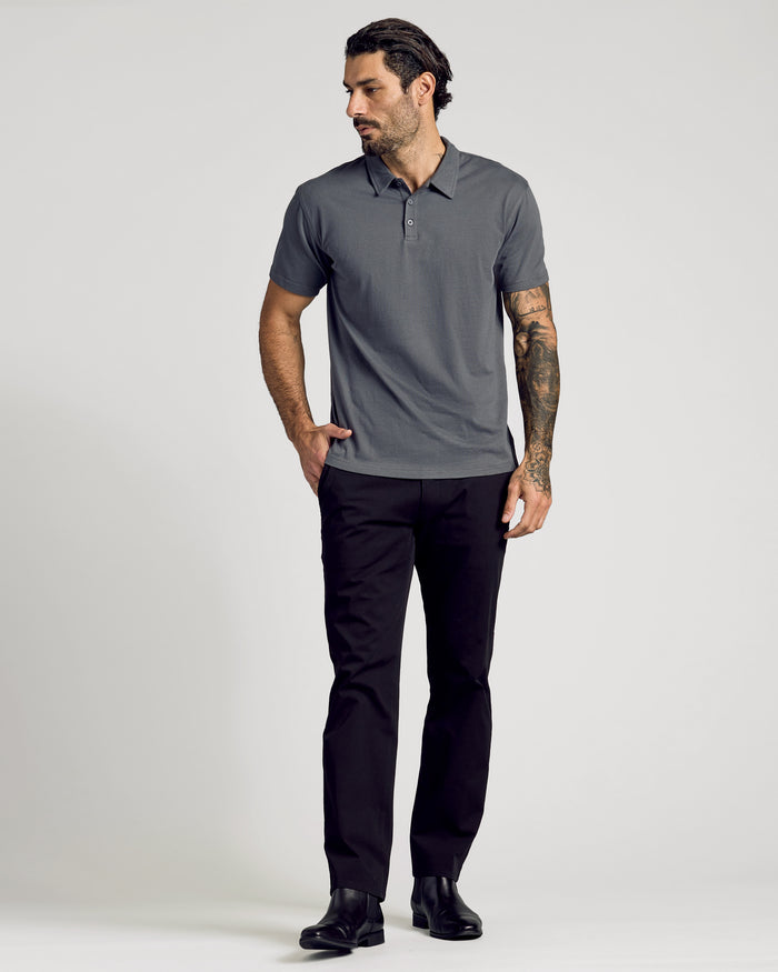 Man wearing Carbon Classic Polo with black pants and boots.