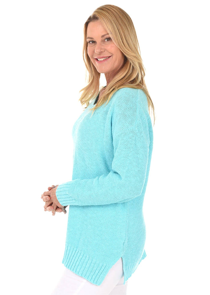 Woman wearing a light blue sweater on a white background