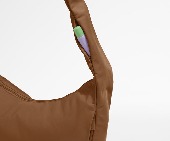 Chapstick in the discreet, zippered strap pocket