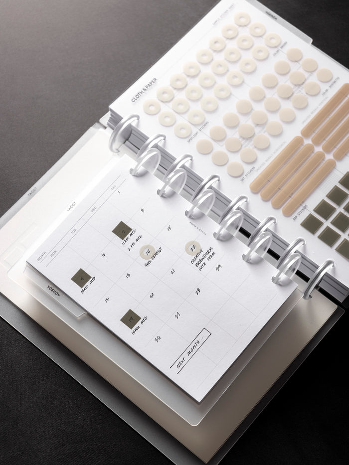 Open Forma Modular Planner System in CP Petite shown on top of Half Letter against a dark background.