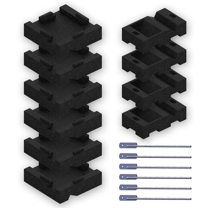 Overhead view of black foam leveling blocks stacked in two columns beside six metal anchoring stakes for swing set stabilization