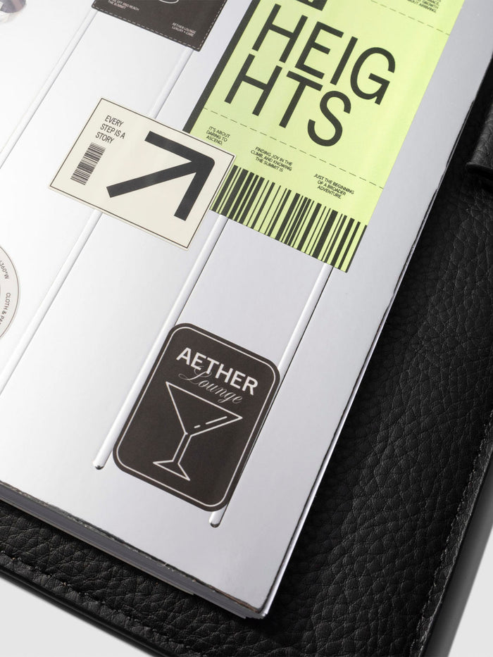 Closeup of dashboard in a black leather planner displayed on a neutral background. Size shown is CP Petite.