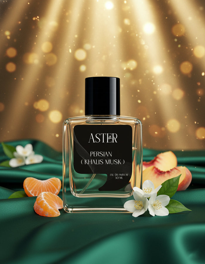 Perfume bottle labeled 'Aster' with fruits and flowers on a green fabric background