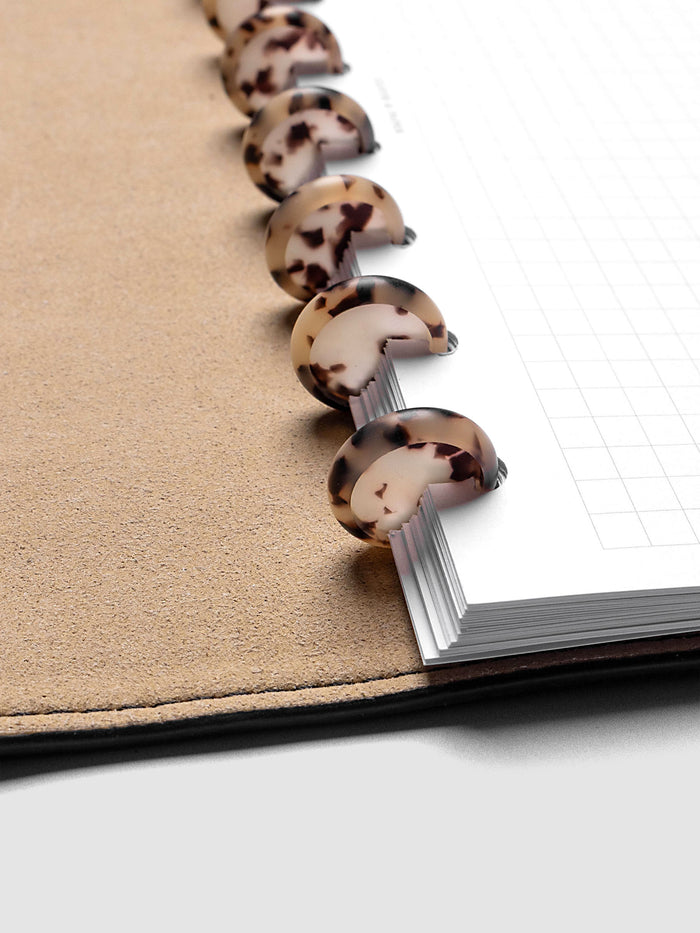 0.75" Inch Desert Tortoiseshell Planner Discs shown in use as binding with planner inserts.