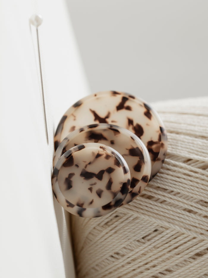 Three sizes of Desert Tortoiseshell planner discs against a light background.