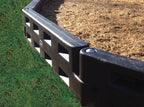 Black Plastic Playground Border with Spike edging wood chip surface and grass, durable lightweight retaining system