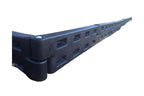Black plastic interlocking playground border with spike and rectangular cutouts, angled close-up showing textured surface and connection design