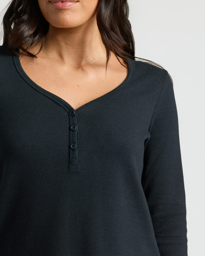 Womens Black Waffle Long Sleeve Henley worn by model, scooped neckline.